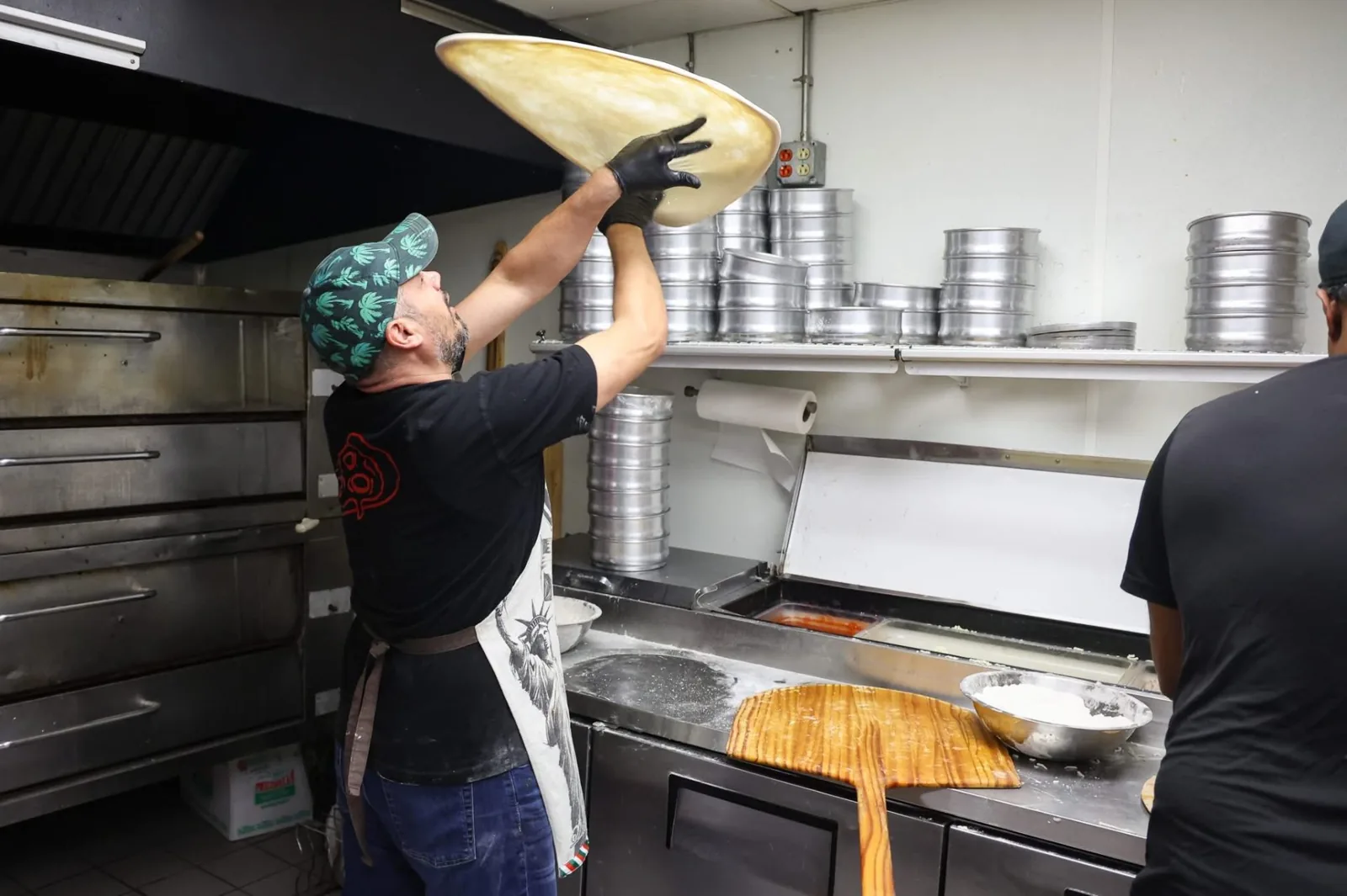 Verona's pizzaiolo hand-tossing fresh dough in the Fairborn kitchen